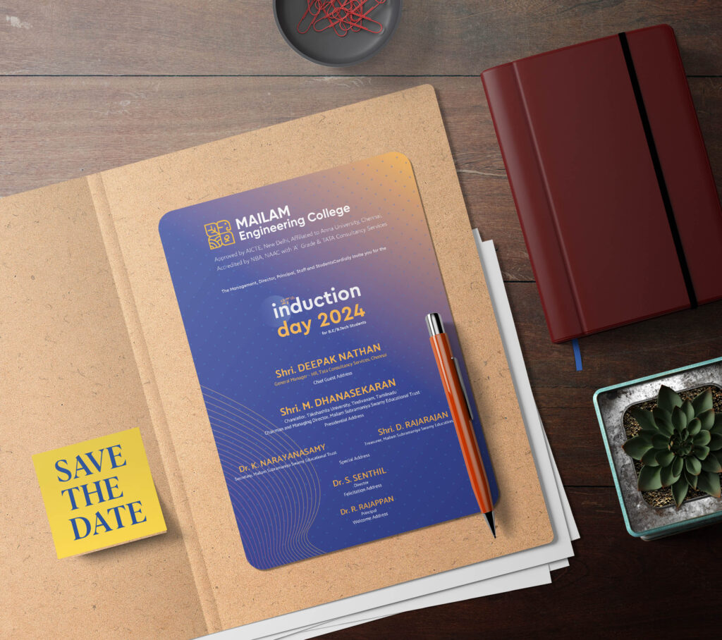 Top-down view of a corkboard featuring an induction day 2024 invitation card for Mailam Engineering College. The card is placed beside a red journal, a silver pen, a plant, and a yellow 'Save the Date' sticky note. The card highlights key guests and event details, with a gradient blue and orange design. The setup is stylish and neat, ideal for showcasing invitation designs in a professional setting.