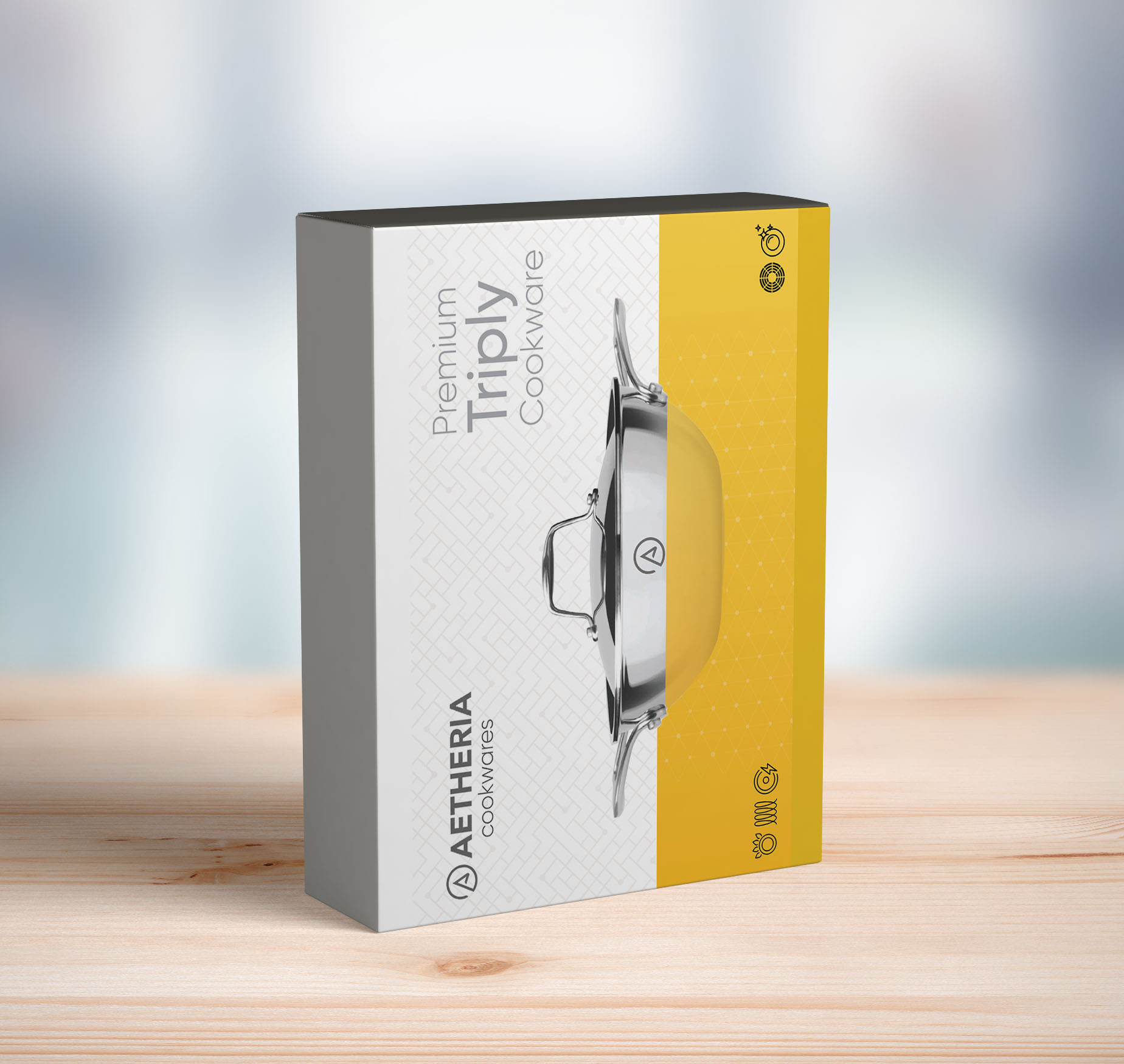 A product box for Aetheria Cookwares' Premium Trophy Cookware is displayed on a wooden table. The box features an image of a stainless steel pot with a glass lid on a bright yellow background. The brand name and product details are printed in a sleek design.